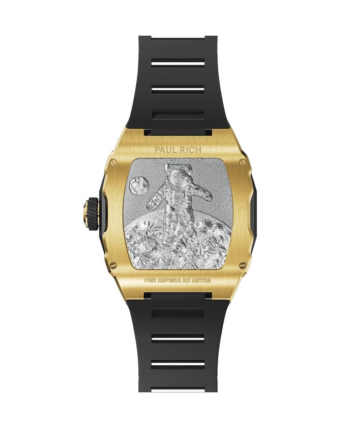 Caseback of Paul Rich watch with gold casing, engraved astronaut on lunar surface, black rubber strap, and “PER ASPERA AD ASTRA” text.