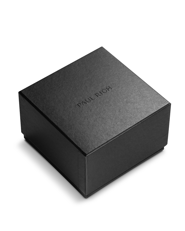 Angled view of closed black Paul Rich watch box with subtle textured finish and embossed logo on lid, shown on white background.