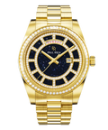 Gold watch with a blue aventurine dial, day and date windows, and a bezel and hour markers set with clear stones on a full gold bracelet.