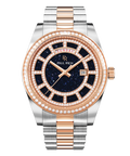 Two-tone silver and rose-gold watch with a blue aventurine dial, day and date windows, and a bezel and hour markers set with crystal stones.