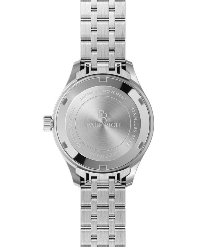 Back view of a silver-tone Paul Rich watch with engraved text: “Paul Rich,” “Japanese Movement,” “Stainless Steel,” “Water Resistant,” and “Crystelle.”