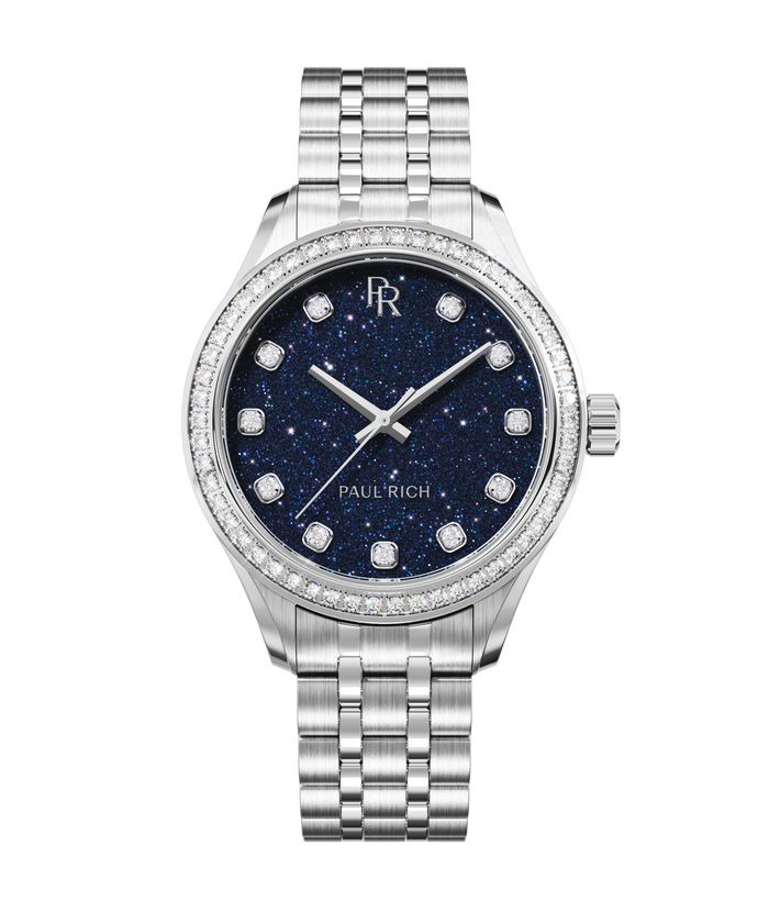 Front view of a silver-tone Paul Rich watch with a deep blue aventurine dial, diamond hour markers, gem-set bezel, and silver jubilee bracelet.