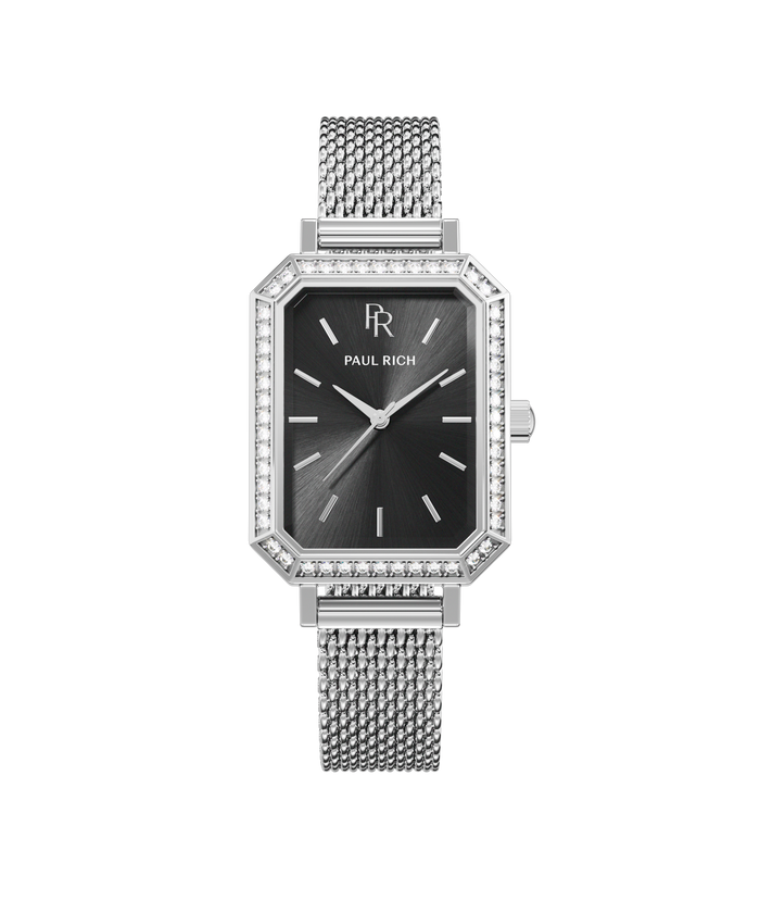 Front view of a silver-tone Paul Rich watch with black sunray dial, gem-set octagonal bezel, and silver mesh strap.