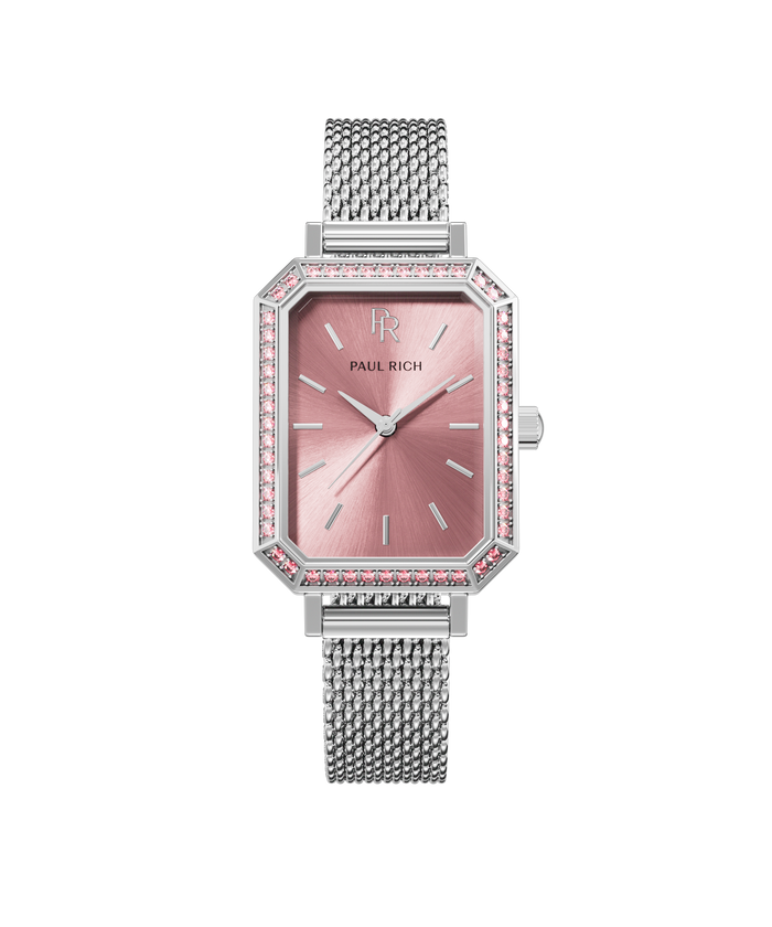 Front view of a silver-tone Paul Rich watch with pink sunray dial, gem-set octagonal bezel featuring pink stones, and a silver mesh strap.