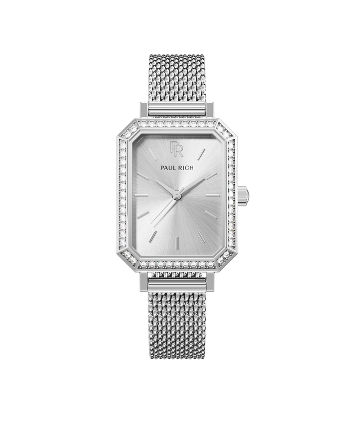 Front view of a silver-tone Paul Rich watch with silver sunray dial, gem-set octagonal bezel, and silver mesh strap.
