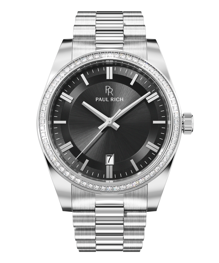Front view of a silver-tone Paul Rich watch with black sunray dial, diamond-set bezel, silver hour markers and hands, date display at 6 o'clock, and silver link bracelet.