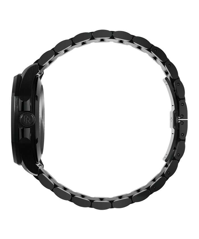 Side view of Paul Rich watch with brushed black case, PR monogram crown, and closed black metal bracelet forming a circular loop.