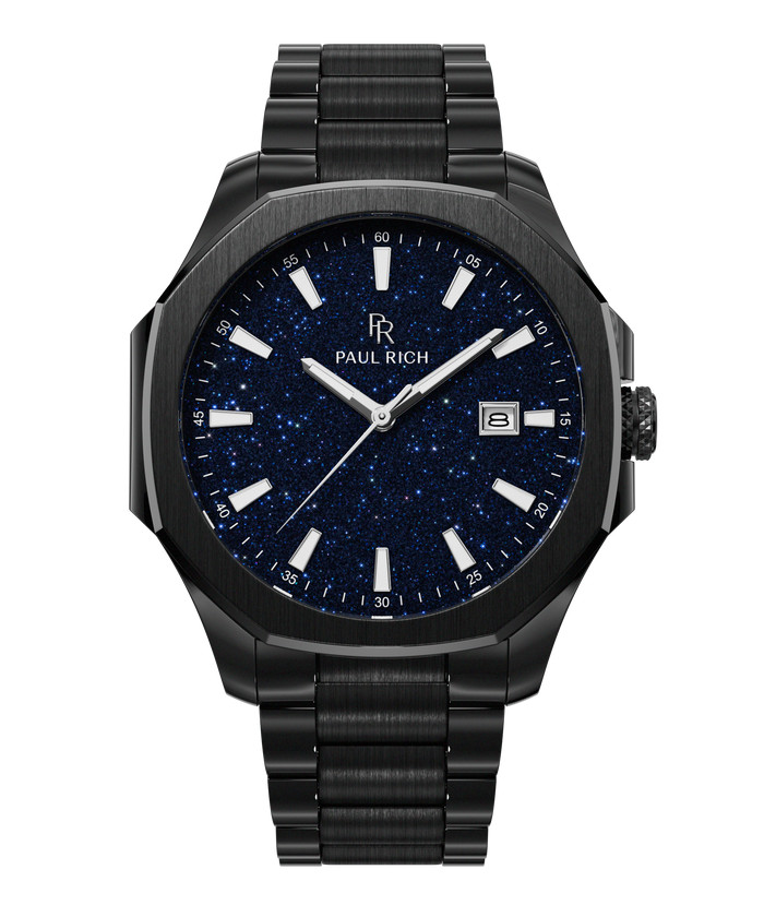 Front view of Paul Rich watch with brushed black case and bracelet, blue aventurine dial, silver indices, and date window at 3 o’clock.